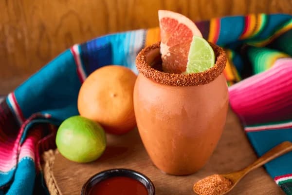 Cantarito : Refreshing Mexican cocktail traditionally served in a clay cup to enhance its flavors.